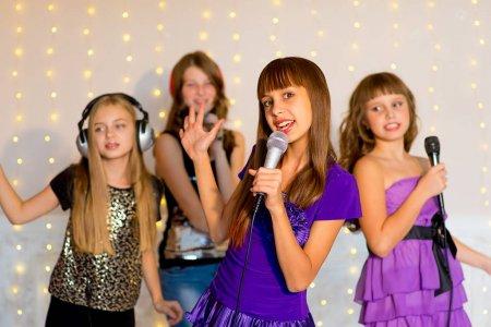 Depositphotos 131037480 stock photo group of happy girls singing